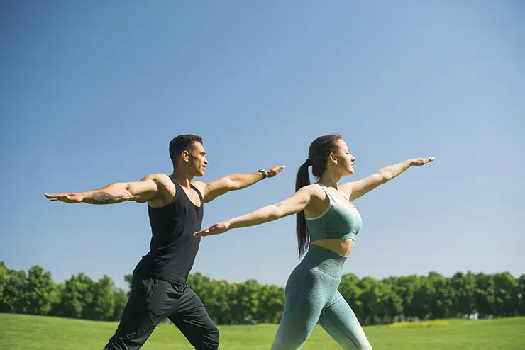 man woman practicing yoga outdoor